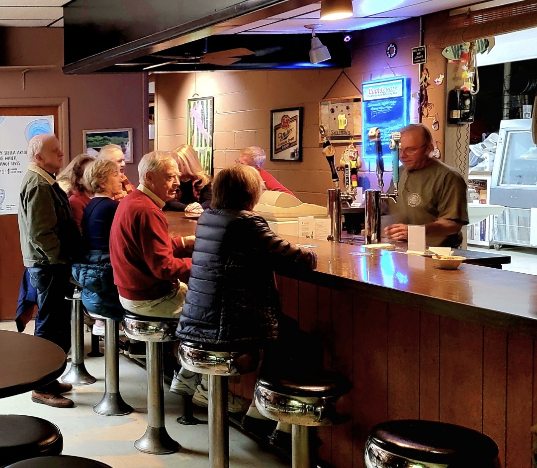 Guests waiting at the bar, ready to grab their drinks at The Shuck Shack.