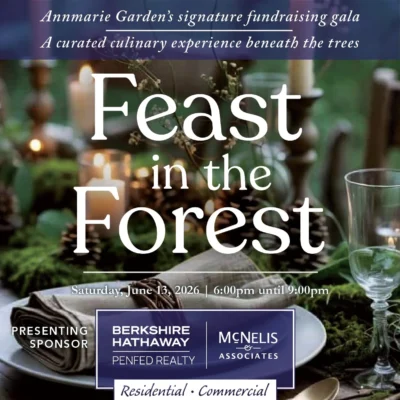 A promotional graphic for "Feast in the Forest," Annmarie Garden’s signature fundraising gala. The background features a rustic, candlelit outdoor dinner setting with greenery and pinecones. Text identifies the event date as Saturday, June 13, 2026, from 6:00 pm to 9:00 pm. The bottom of the image features logos for Berkshire Hathaway HomeServices PenFed Realty and McNelis & Associates, labeled as the "Presenting Sponsor" for both residential and commercial real estate.