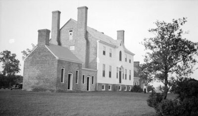 1937 historic photograph by Thomas T. Waterman for the Historic American Buildings Survey, showing the south elevation of Rose Hill, the Dr. Gustavus Brown House near Port Tobacco, with its two-story frame structure, brick chimneys, and wings.